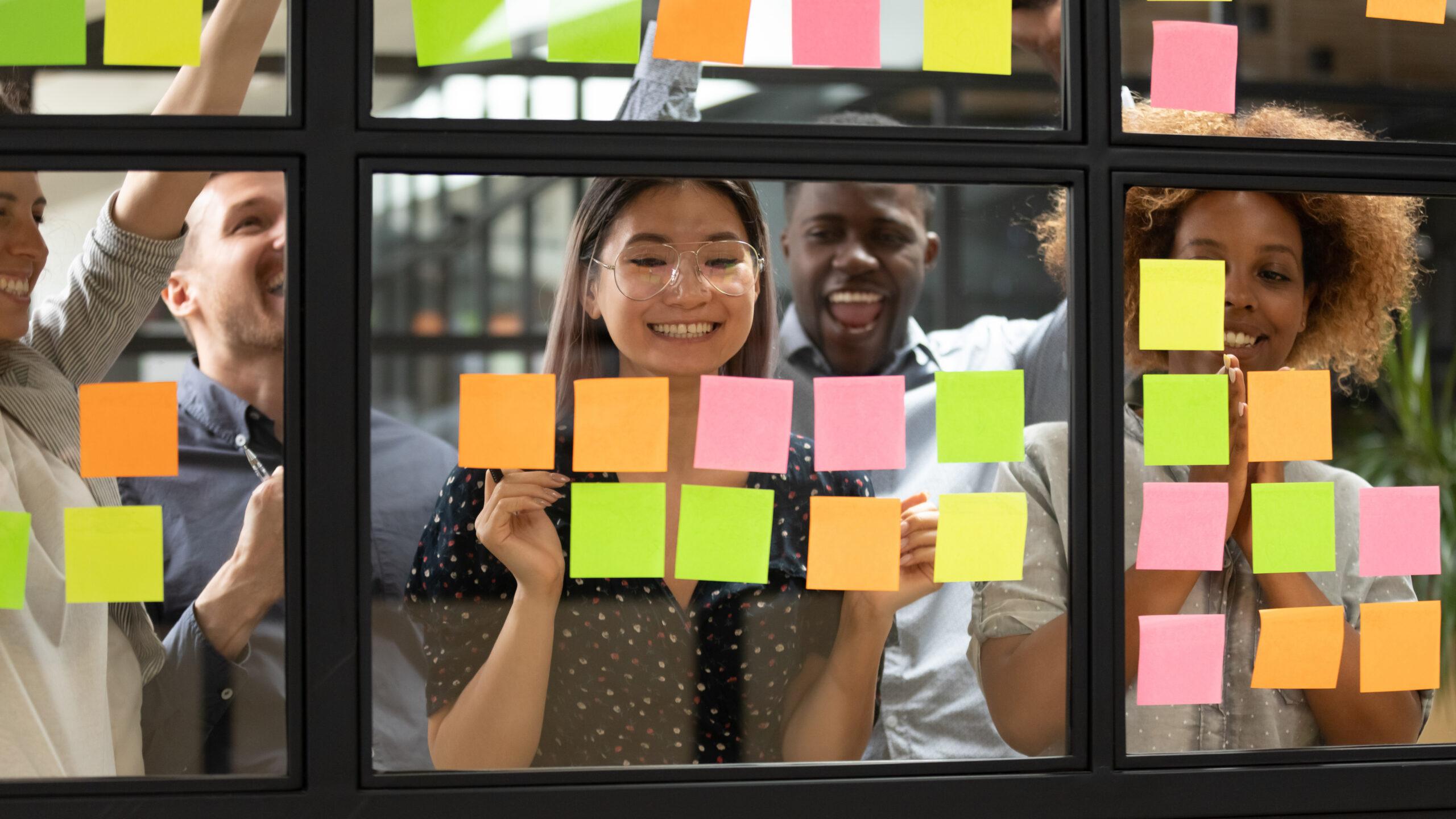 Happy diverse team celebrating corporate goal achievement